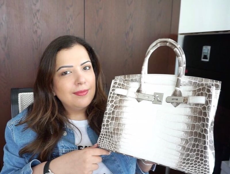 @howshespendsit poses with her Himalayan Birkin
