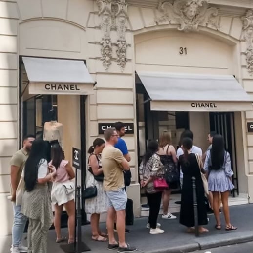 Customers standing in long line in front of Chanel Flagship store in Paris