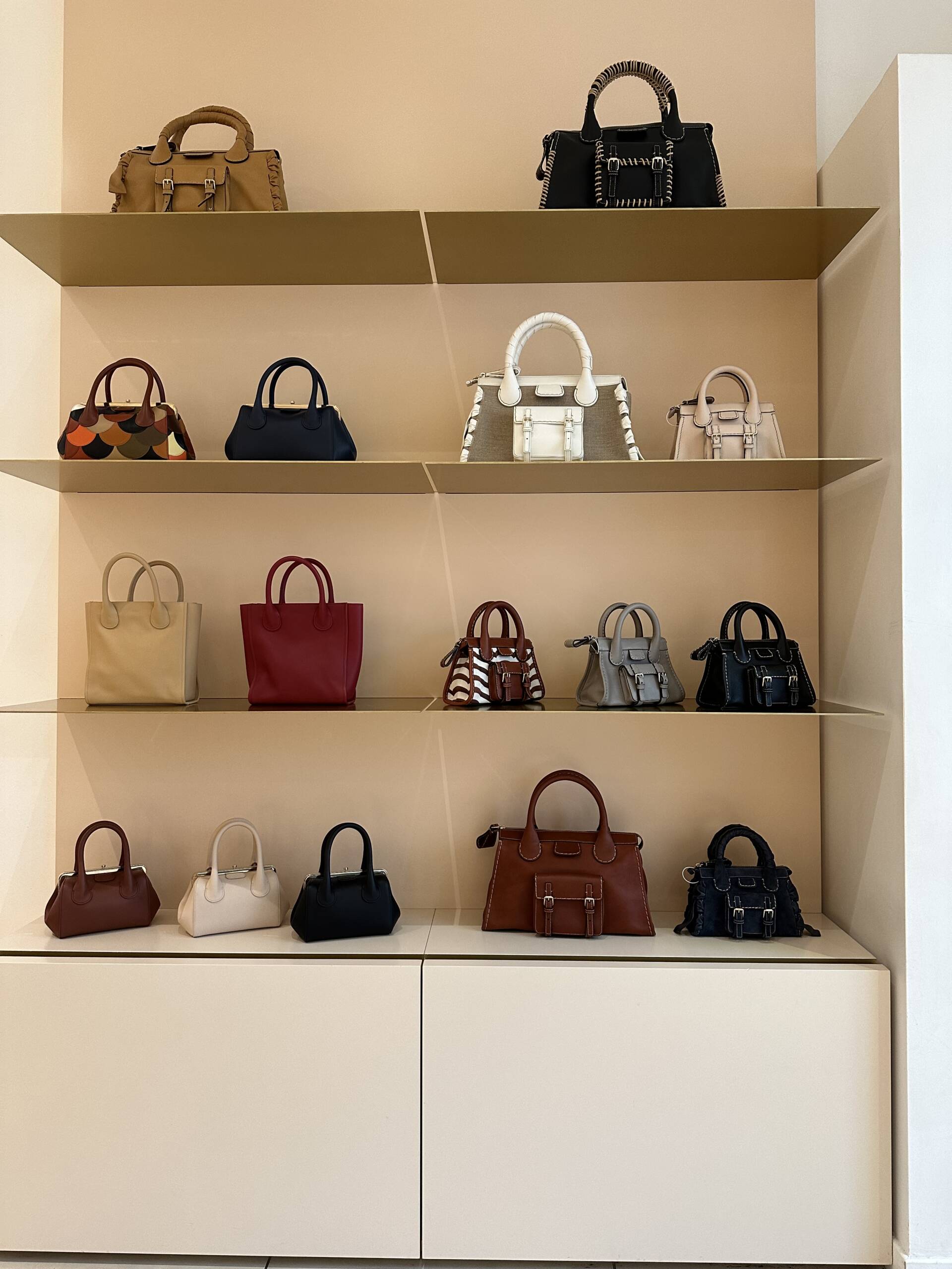 Shopping for Chloe handbags on display at La Vallee Village in Paris.