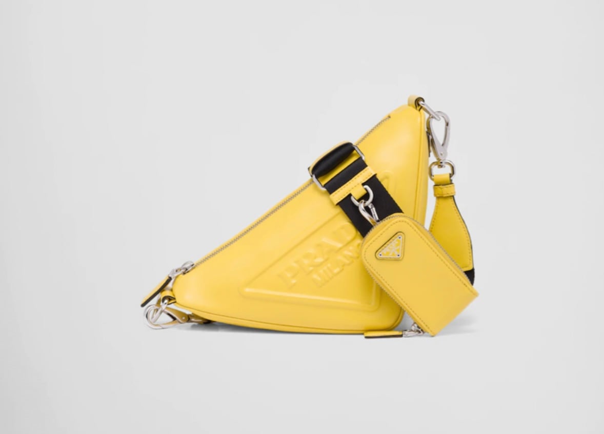 Emily in Paris Season 3 Episode 7, Lily Collins is wearing this yellow triangle Prada cross body bag.