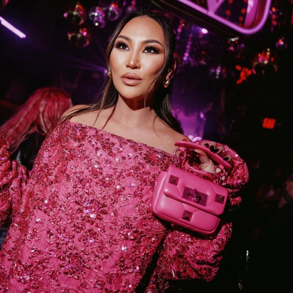 Dorothy Wang Bling Empire NYC wearing a sequin hot pink Valentino dress with a matching Valentino pink mini bag