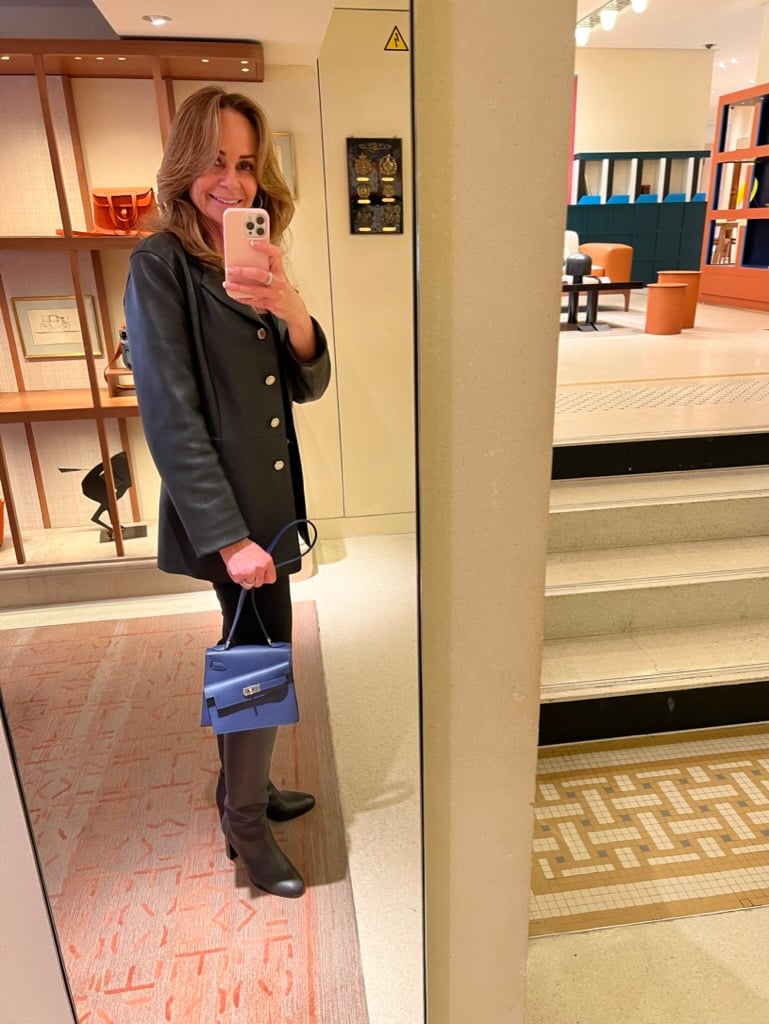 Close-up of Hermès Kelly en Désordre in Bleu Saphir, photographed inside Hermès Paris flagship store.
