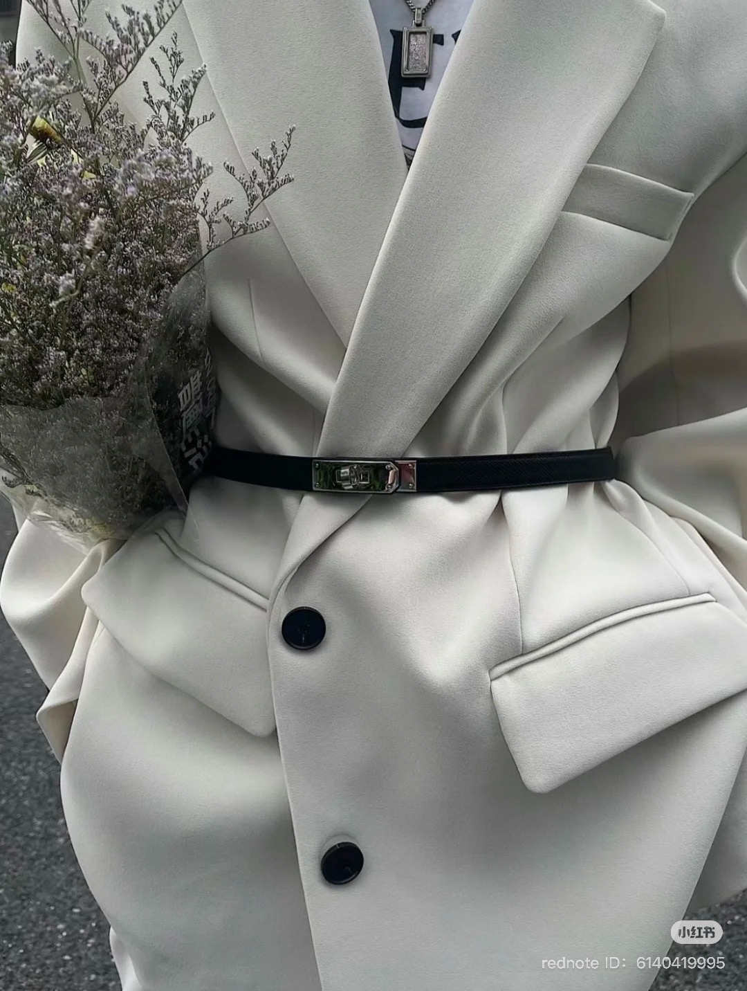 black hermes kelly 18 belt styled over a oversized coat