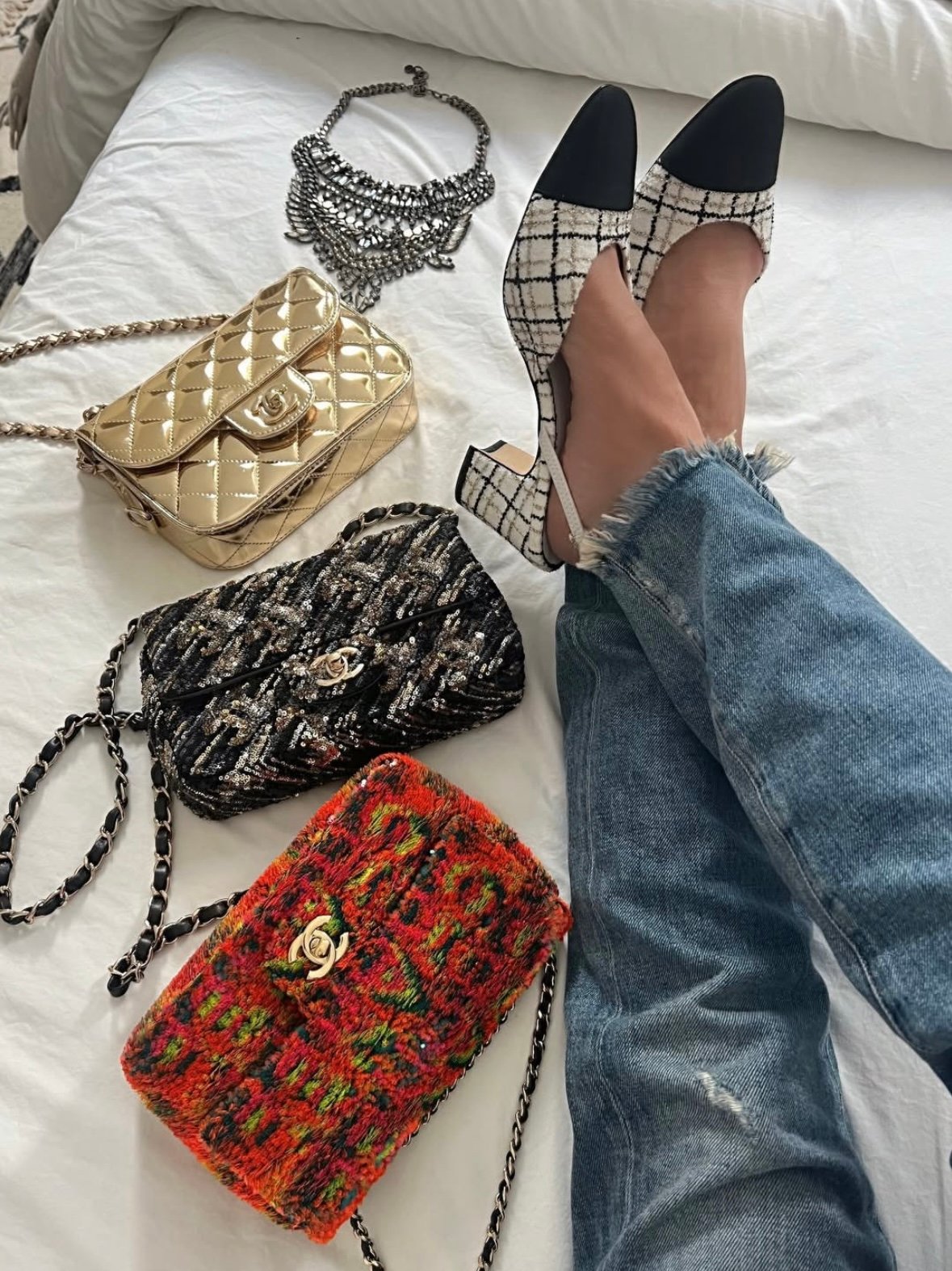 A collection of Chanel Classic Flap bag with gold-tone hardware and quilted leather design, displayed on a white background.